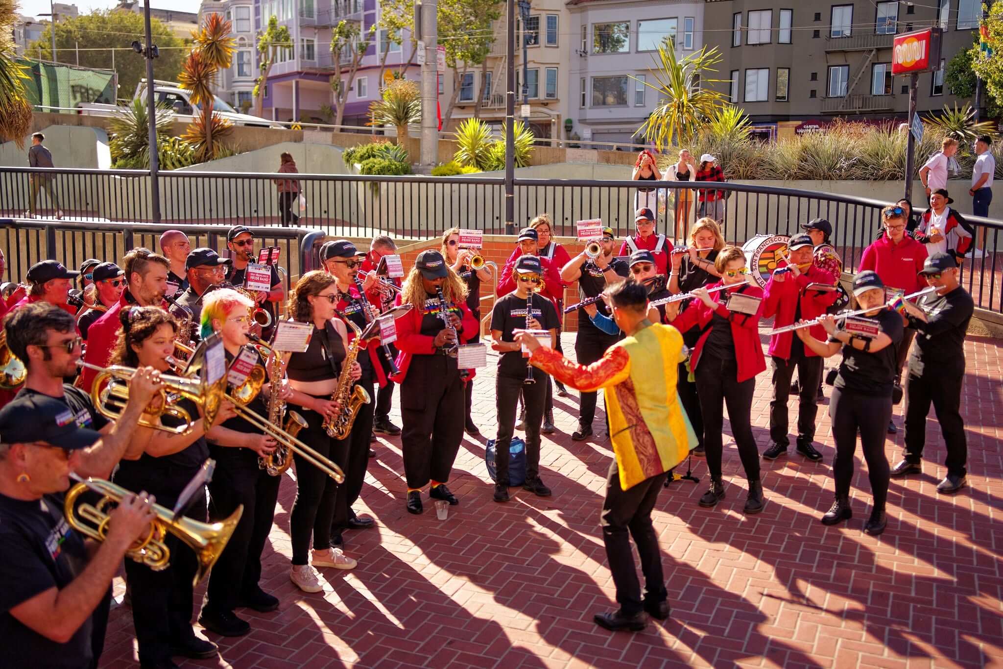 Members of the San Francisco Pride Band performing outdoors in the Castro